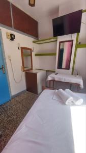 a bedroom with a white bed and a sink at Old town Room With Window in Rethymno +1 photo