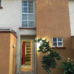 a door to a building with a red door at Estrella 2 senderos del lago in Chantepec