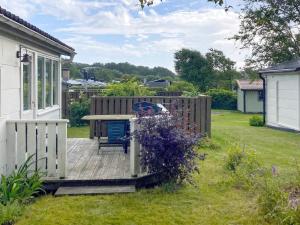 a garden with a wooden fence and a bench at 4 person holiday home in FALKENBERG-By Traum in Falkenberg +9 photos