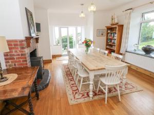 a dining room with a table and chairs at Penmarth House in Helston