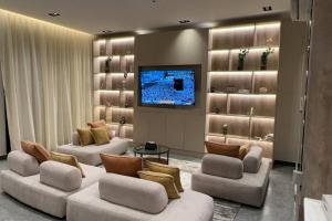a living room with two couches and a flat screen tv at The N&N Appt in Medina