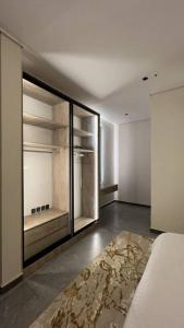 an empty room with a bed and a large closet at The N&N Appt in Al Madinah