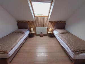 two beds in a small room with a window at Villa VIP in Welkenraedt +50 photos