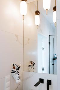 a bathroom with a sink and a mirror at Apartament z widokiem na jezioro in Charzykowy +27 photos