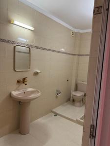 a bathroom with a sink and a toilet at Апартамент Александър in Sunny Beach +3 photos