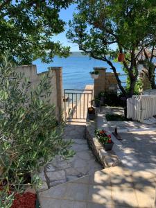a walkway with a view of the ocean at Apartman LIVE in Posedarje