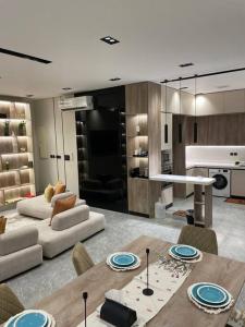 a kitchen and living room with a table and chairs at The N&N Appt in Al Madinah