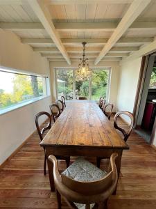 a dining room with a wooden table and chairs at La Mulattiera - vista lago in Baveno +24 photos