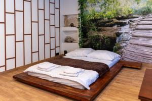 Posteľ alebo postele v izbe v ubytovaní JapanApartment - Jacuzzi
