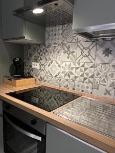 a kitchen with a counter top and a tile wall at Villa Gabri in Casa Berta +30 photos