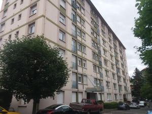 a large white building with cars parked in front of it at La Tardiere #Confort#Calme in Clermont-Ferrand