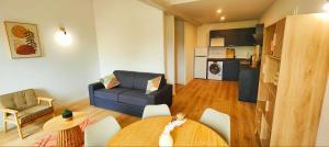 a living room with a table and a couch at Joli Appart Le Moderne Design in Clermont-Ferrand