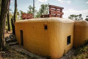 a building with a chair sitting on top of it at Vojenský bunker B in Bratislava
