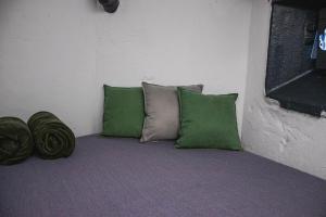 a group of green pillows sitting in a room at Vojenský bunker B in Bratislava