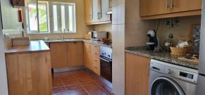 a kitchen with a sink and a dishwasher at Santa Luzia Apartment in Santa Luzia