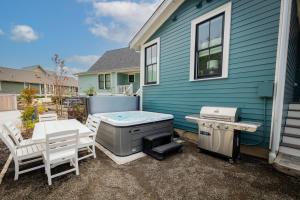 a backyard with a hot tub and a grill at Starry Meadow by Seabrook Hospitality in Pacific Beach
