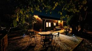a table and chairs in front of a house at night at Chalet Villa Mosquito in Silves