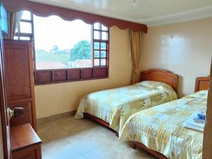 Hotel El Dorado Guatavita客房内的一张或多张床位