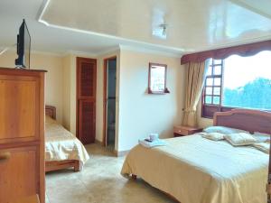 Hotel El Dorado Guatavita客房内的一张或多张床位