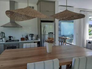 a kitchen with a large wooden table with chairs at Casa en El lucero, Pilar in Manuel Alberti +5 photos