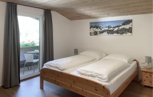a large bed in a room with a window at Ferienwohnung St, Gallenkirch in Sankt Gallenkirch