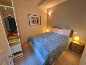 a small bedroom with a bed and a tv at Anciua - Parking Free in Camogli