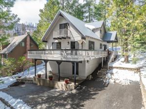 a large house with a porch and a balcony at Ridgeview Retreat Location Meets Comfort Ac! in Shaver Lake