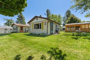 a home with a yard with a house at Chippewa Bluffs Resort - 2BR 2BA Cabins in Barryton