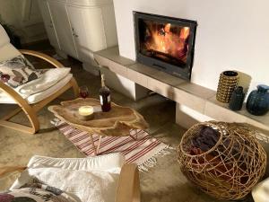 a living room with a fireplace and a couch at Holiday Home in Ró ewko with Pool and Orchard in Ubiedrze