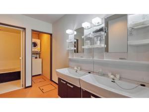 un bagno con un lavandino bianco e uno specchio di AMA TERRACE - Vacation STAY 31138v ad Amami Altre 50 foto