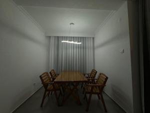 a dining room with a wooden table and chairs at Art Apartment 2 in Prishtinë