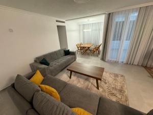 a living room with a couch and a table at Art Apartment 2 in Prishtinë