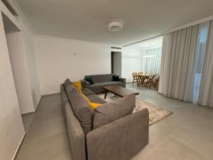 a living room with a couch and a table at Art Apartment 2 in Prishtinë