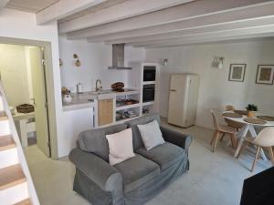 a living room with a couch and a kitchen at Da Calcada ao Rio in Alcácer do Sal
