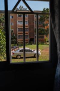 a view of a car parked outside a window at Blissful Homes in Kampala