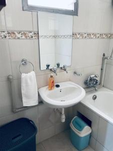 a bathroom with a sink and a mirror at Blissful Homes in Kampala +12 photos