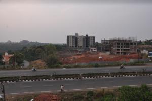 a view of a highway with buildings in the background at Hotel Dewa Goa in Dabolim