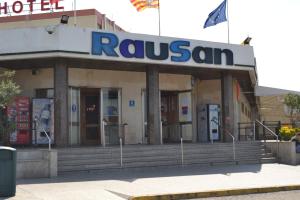 a building with a hotel with a sign on it at Hotel Rausan in Alfajarín