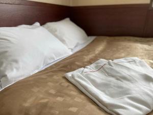 a bed with a pair of white clothes on it at Fuji Park Hotel - Vacation STAY 23854v in Fuji