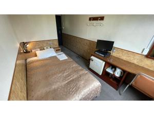 a room with two beds and a desk with a laptop at Fuji Park Hotel - Vacation STAY 23849v in Fuji