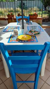 a blue and white table with plates and dishes on it at Casa Marea in Isola delle Femmine