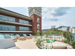 a building with chairs and a building with a clock tower at ROYAL CHESTER NAGASAKI hotel&retreat - Vacation STAY 30719v in Nagasaki