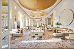 a lobby of a hotel with tables and chairs at Mandarin Oriental Ritz, Madrid in Madrid
