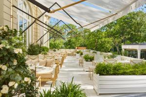 an outdoor patio with tables and chairs and plants at Mandarin Oriental Ritz, Madrid in Madrid
