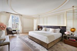a bedroom with a large bed and a living room at Mandarin Oriental Ritz, Madrid in Madrid