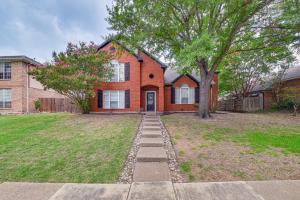 a brick house with a tree in front of it at 10 Mi to Lake Lewisville Carrollton Home with Pool in Carrollton