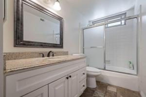 a bathroom with a sink and a toilet and a mirror at Elm Mountain View Fire pit, quiet and more in Los Angeles +21 photos