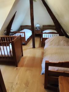 a room with four beds in a attic at Gîte Le Clos Maridor - Grande Longère Normande -15 personnes in Saint-Martin-Saint-Firmin
