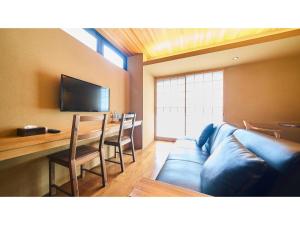 a living room with a blue couch and a table at Kikoku no mori - Vacation STAY 31759v in Kyoto