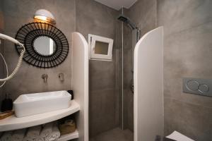 a bathroom with a sink and a shower at Akrogiali Pension in Platis Yialos Sifnos +56 photos